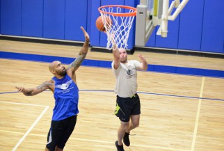 Basketball player blocks shot