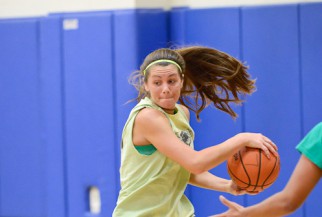 Woman Basketball Player driving to the basket.