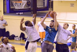 Player getting fouled in basketball league game.