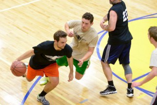 Player in black with the ball in big game in nyc basketball league