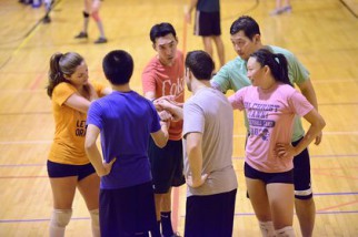 Coed Volleyball Player in a huddle