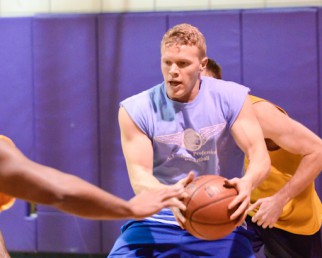 Player fights for the ball in Summer basketball league game