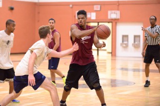 Player controls the ball in nyc basketball league game.